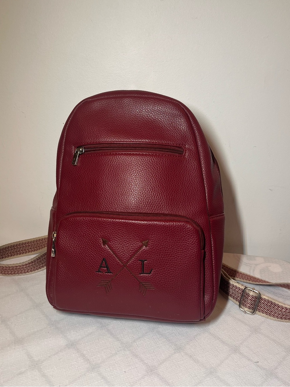 Thirty-One pebble backpack 
Berry maroon 
custom embroidered crossed arrow